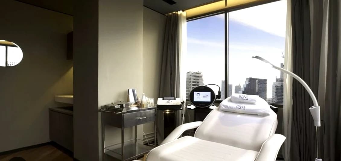 A treatment suite at BRM Clinic in Bangkok, with a view over the city.